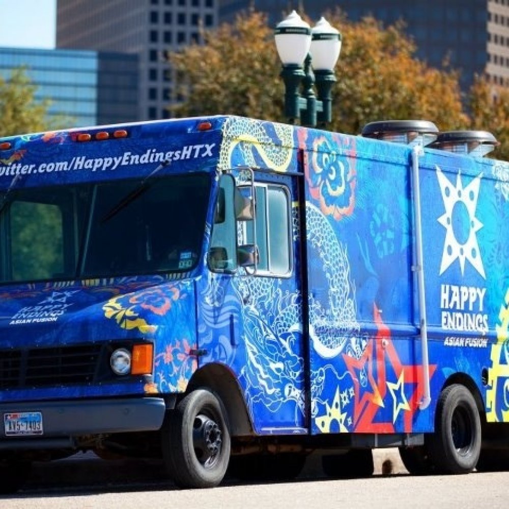 'Happy Endings' blue fusion taco truck parked near the lamp post